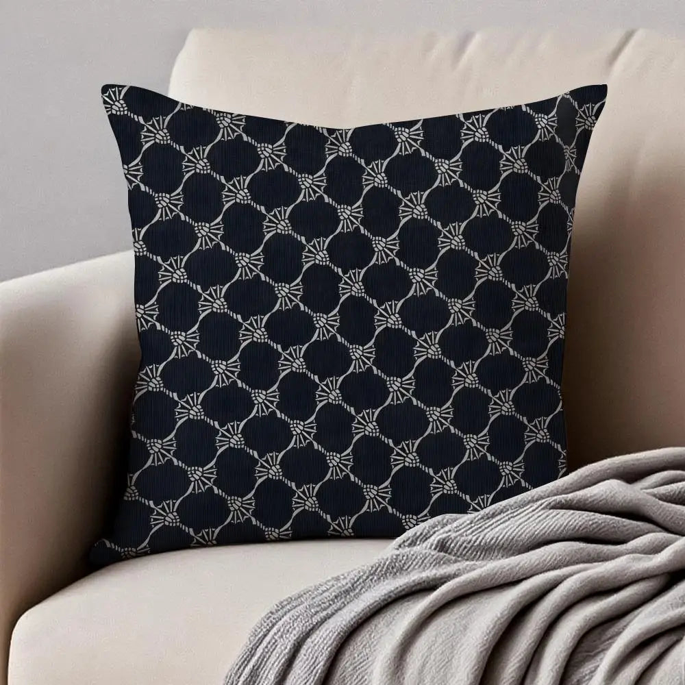 Navy blue pillow with geometric pattern on a beige couch