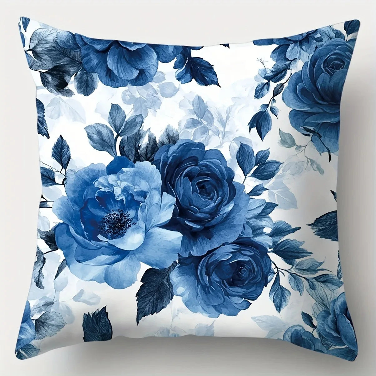Floral pillow with blue roses on a white background