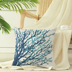Decorative pillow with blue coral design on a chair