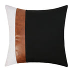 Decorative pillow with black, white, and brown color block design on a white background