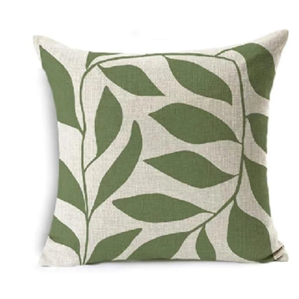 Decorative pillow with green leaf pattern on a white background