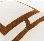 Close-up of a textured pillow with brown and white chevron pattern on a white background