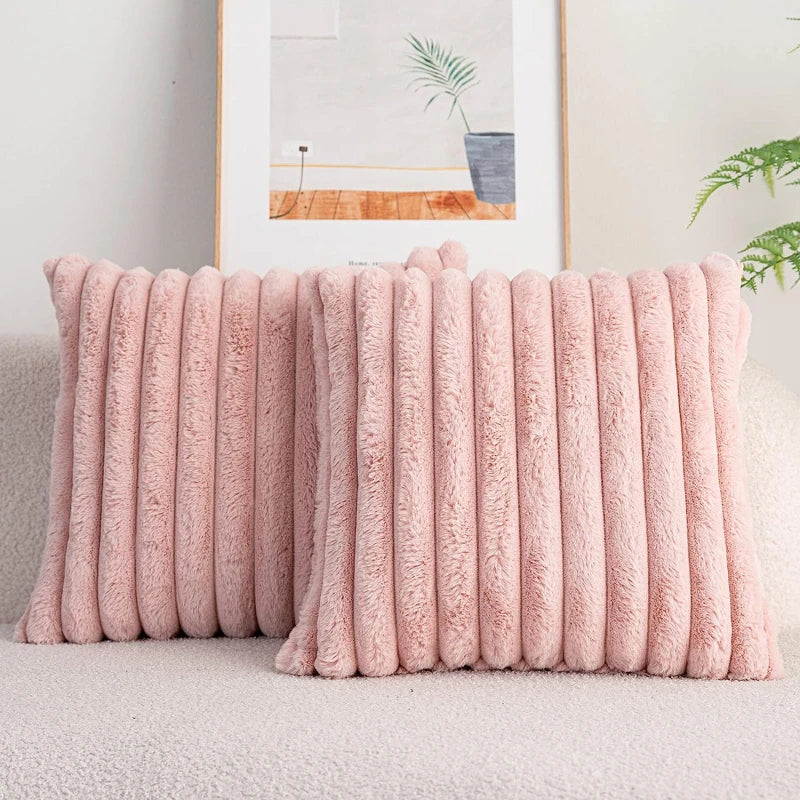 Pink textured throw pillow on a sofa with a neutral background