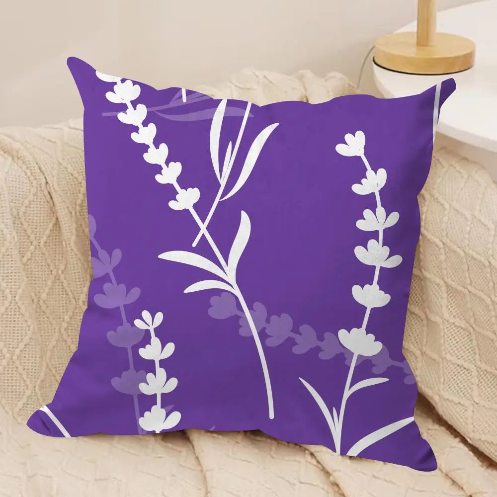 Purple pillow with white floral design on a beige couch