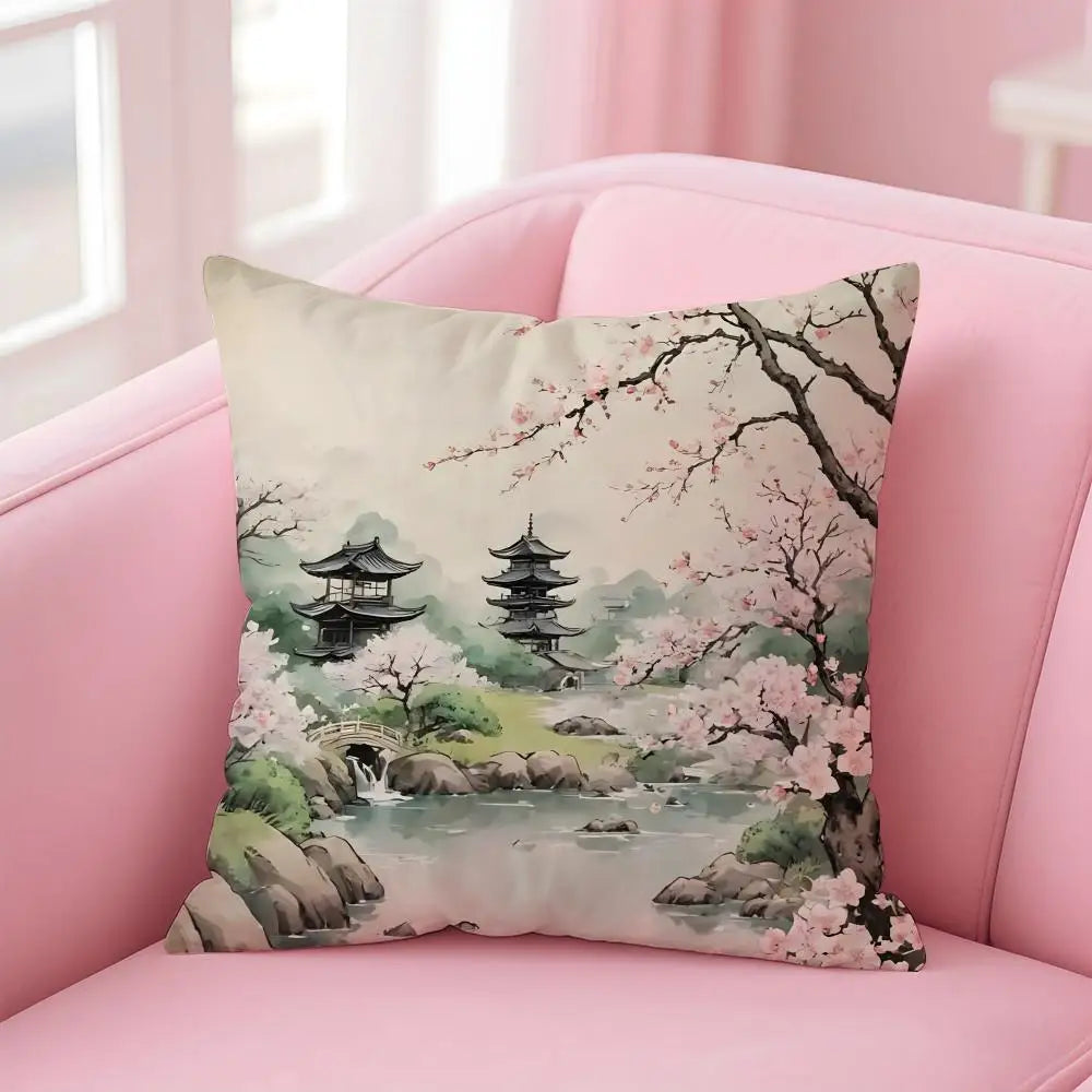 Decorative pillow with cherry blossom and pagoda design on a pink couch.
