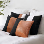 Set of leather and fabric pillows on a bed with a white background