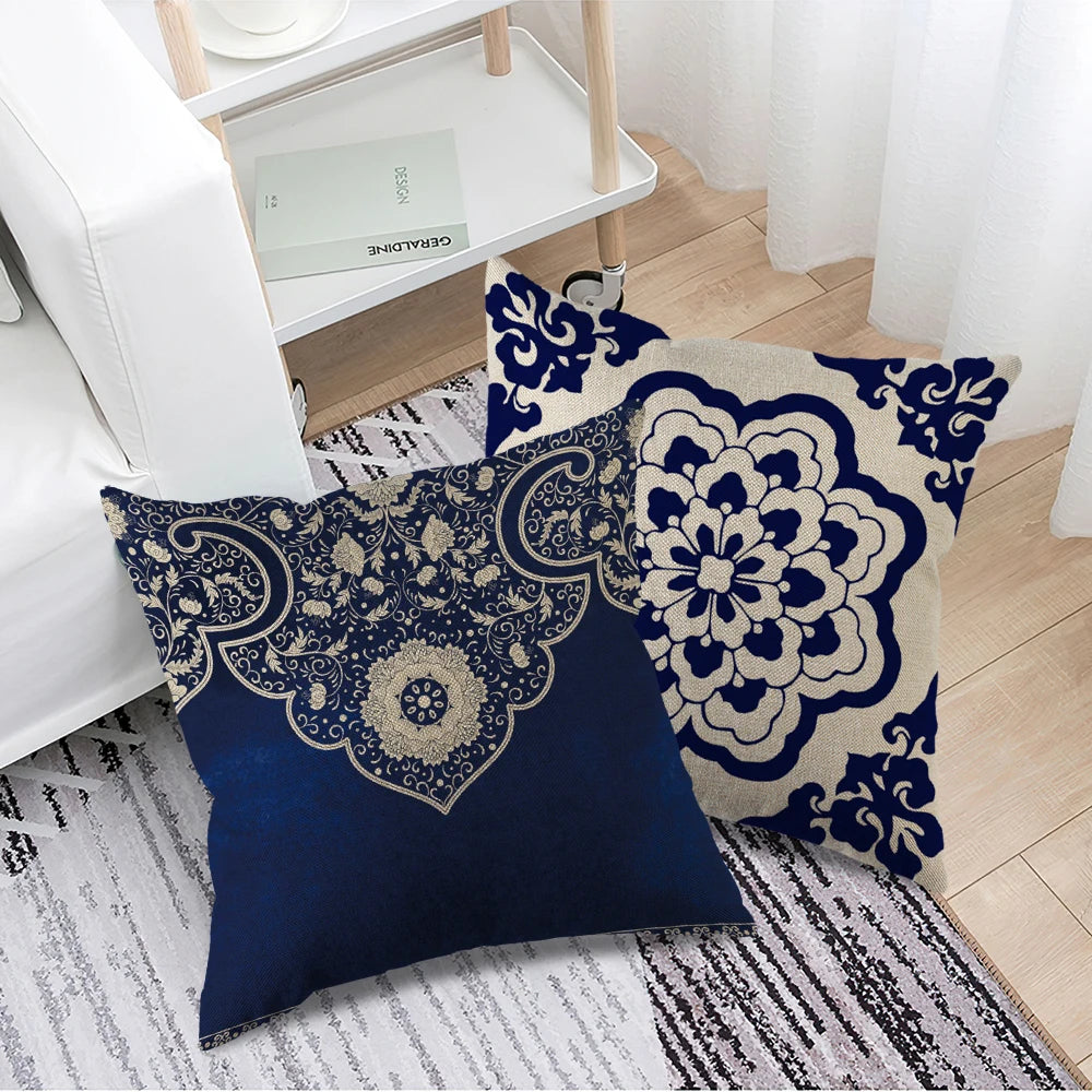 Decorative pillows with blue and white patterns on a rug in a room setting.
