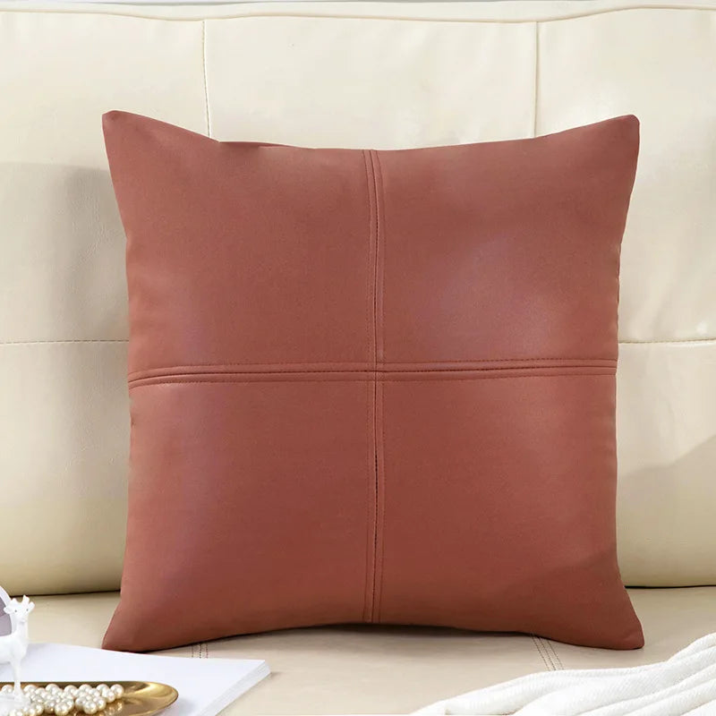 Brown leather pillow on a beige sofa
