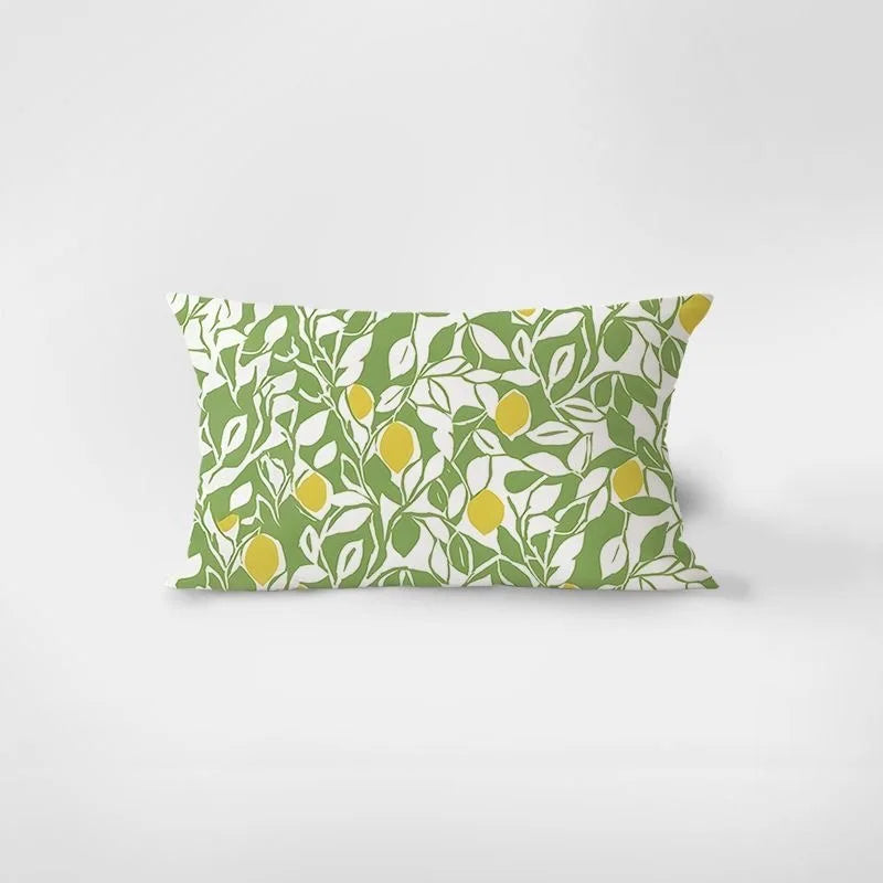 Decorative pillow with lemon and leaf pattern on a light gray background