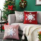 Decorative pillows with snowflake patterns on a couch in a festive living room.