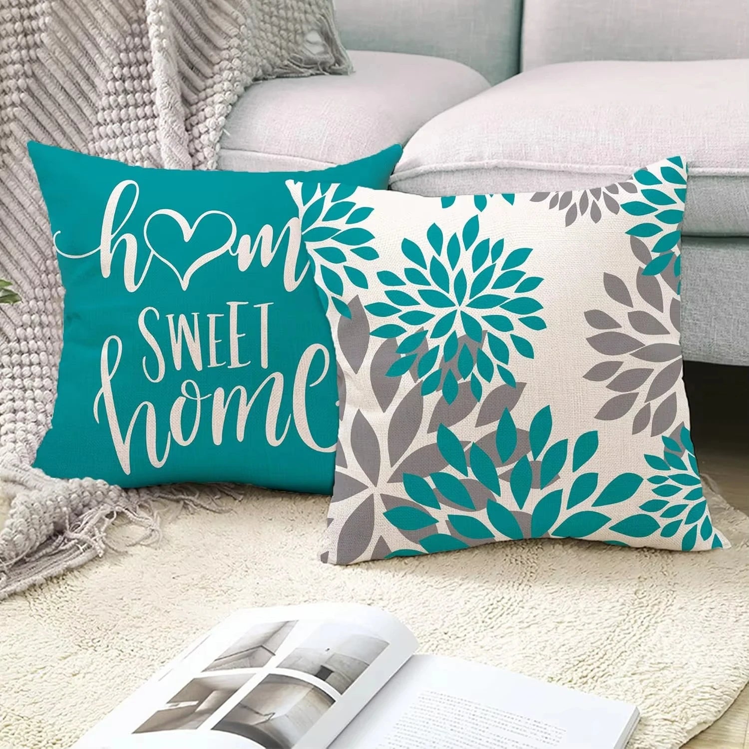 Two decorative pillows on a couch with one reading 'home sweet home' and the other with floral patterns.