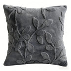 Gray pillow with leaf pattern on a white background