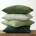 Stacked corduroy pillow covers in light and dark green shades