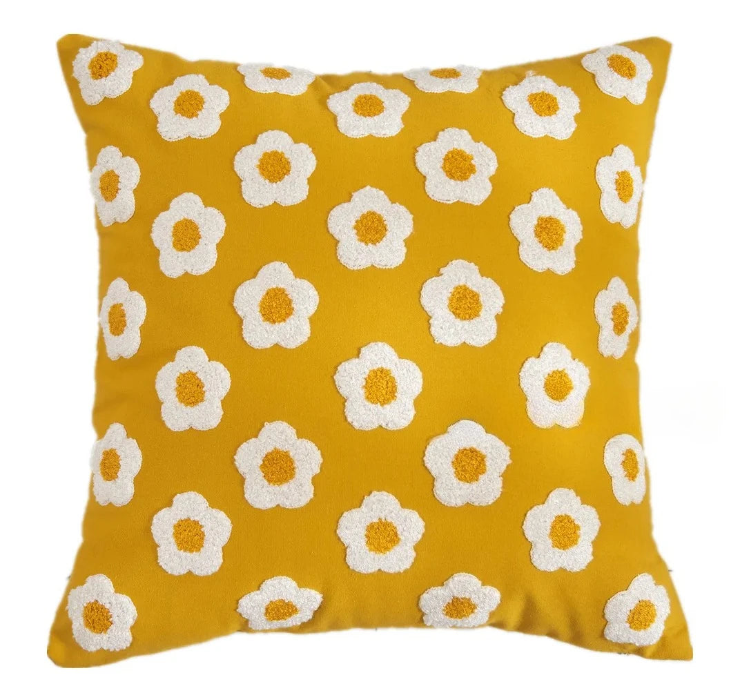 Yellow pillow with white floral patterns