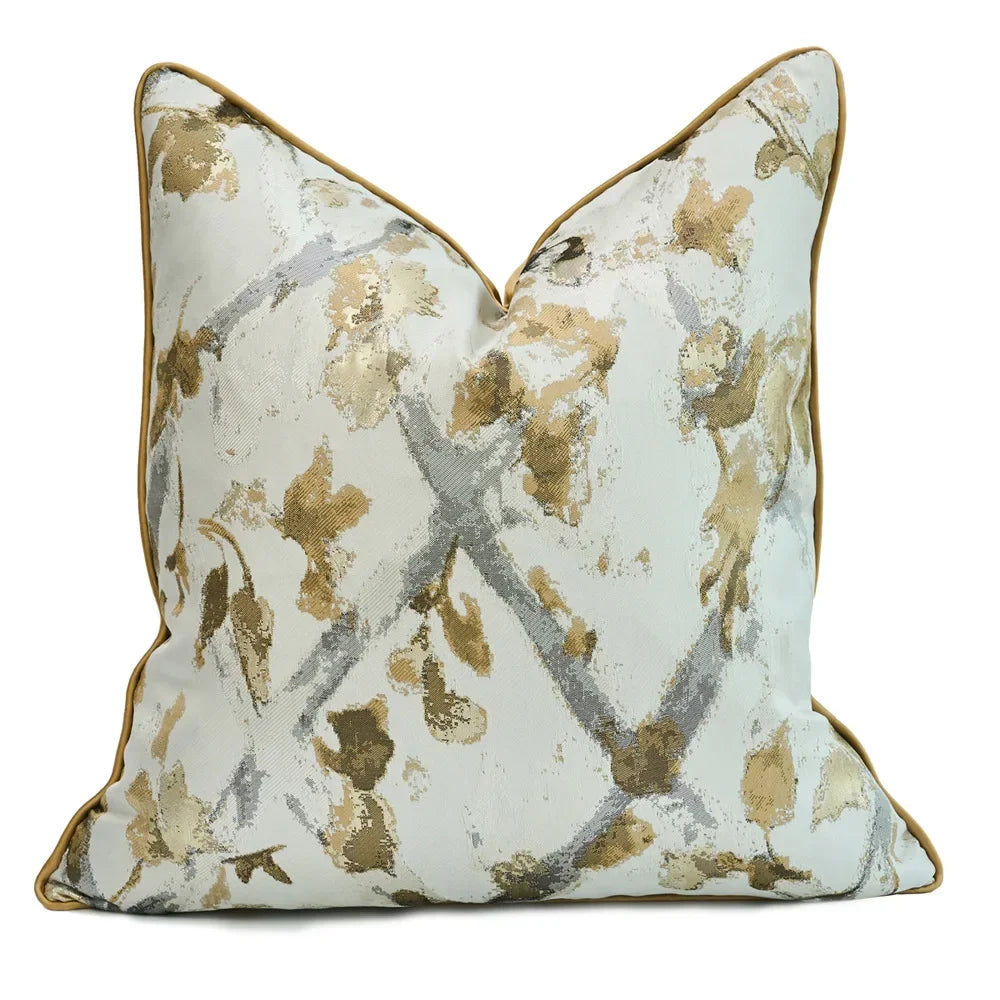 Decorative pillow with gold and gray floral pattern on a white background