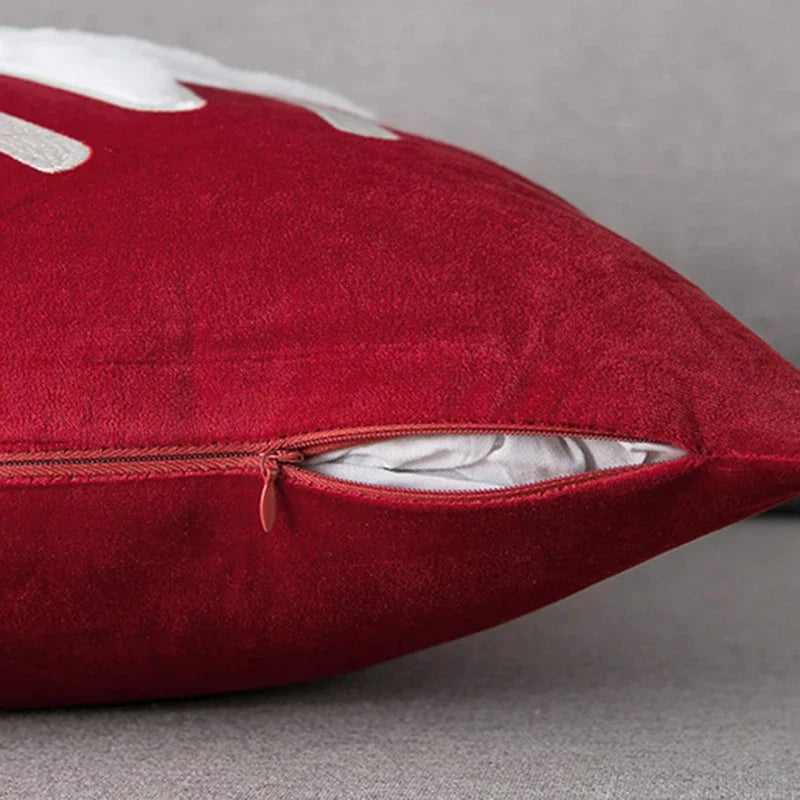 Red pillow with a zipper on a gray background