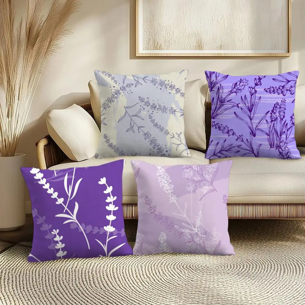 Set of four purple and white floral-patterned pillows on a beige sofa.