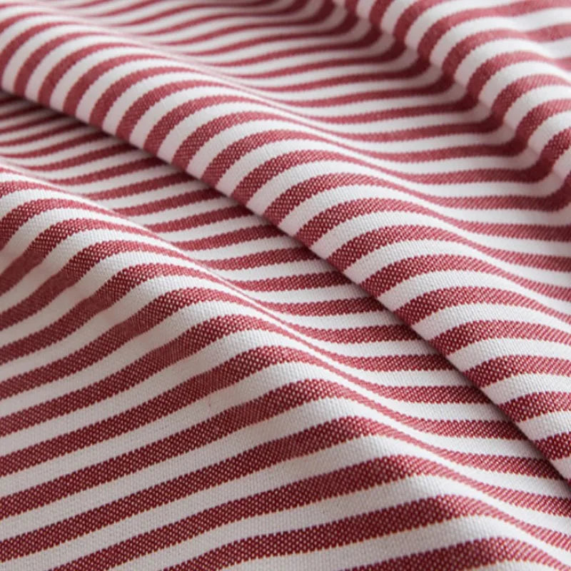 Red striped tassel pillow cover with farmhouse pattern and decorative fringe detail