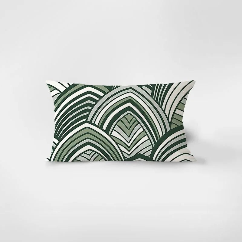 Decorative pillow with green and white geometric pattern on a light gray background