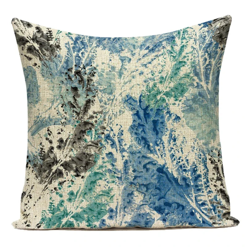 Decorative pillow with blue and green abstract pattern on a white background