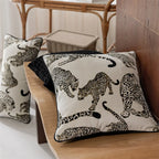 Leopard-patterned cushions on a wooden surface with a blurred background