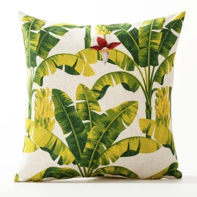 Decorative pillow with tropical leaf pattern on a white background