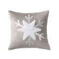 Gray pillow with a large white snowflake design on a white background