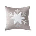 Gray pillow with a large white snowflake design on a white background