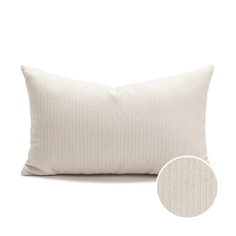 Textured beige pillow with a close-up detail on a white background