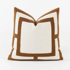 Decorative pillow with brown and white geometric pattern on a white background