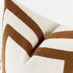 Close-up of a pillow with brown and white chevron pattern on a white background