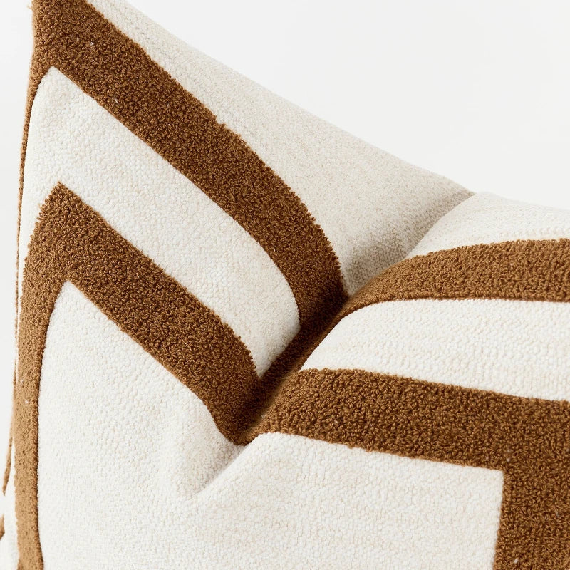 Close-up of a pillow with brown and white chevron pattern on a white background