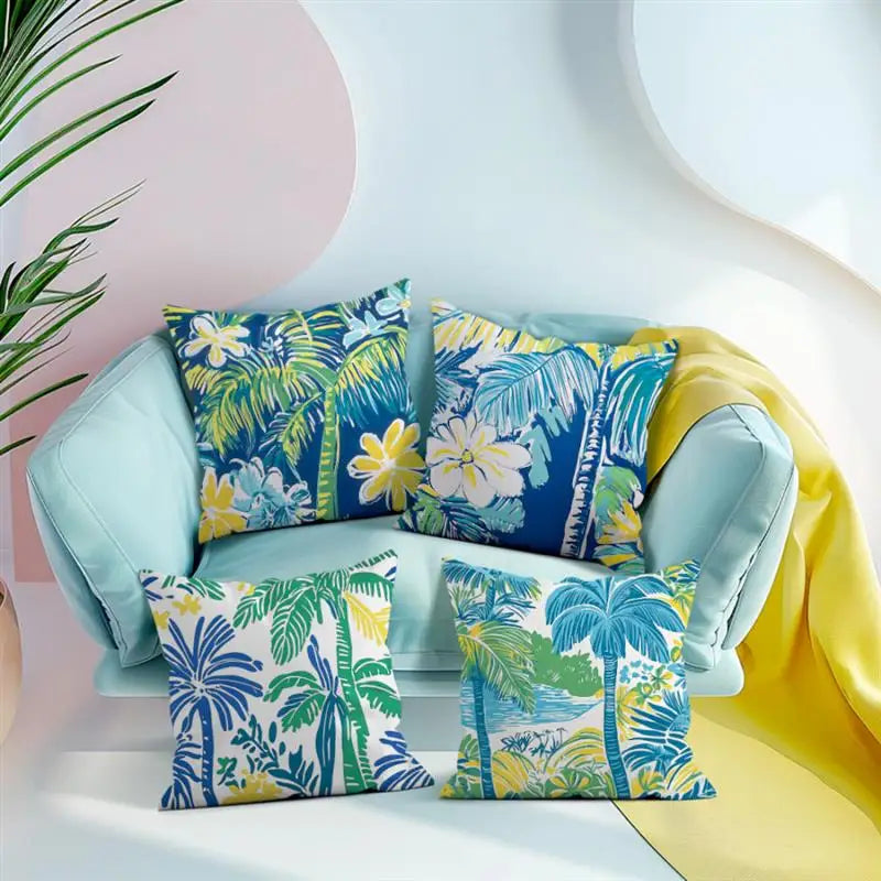 Light blue sofa with tropical patterned cushions against a white wall.