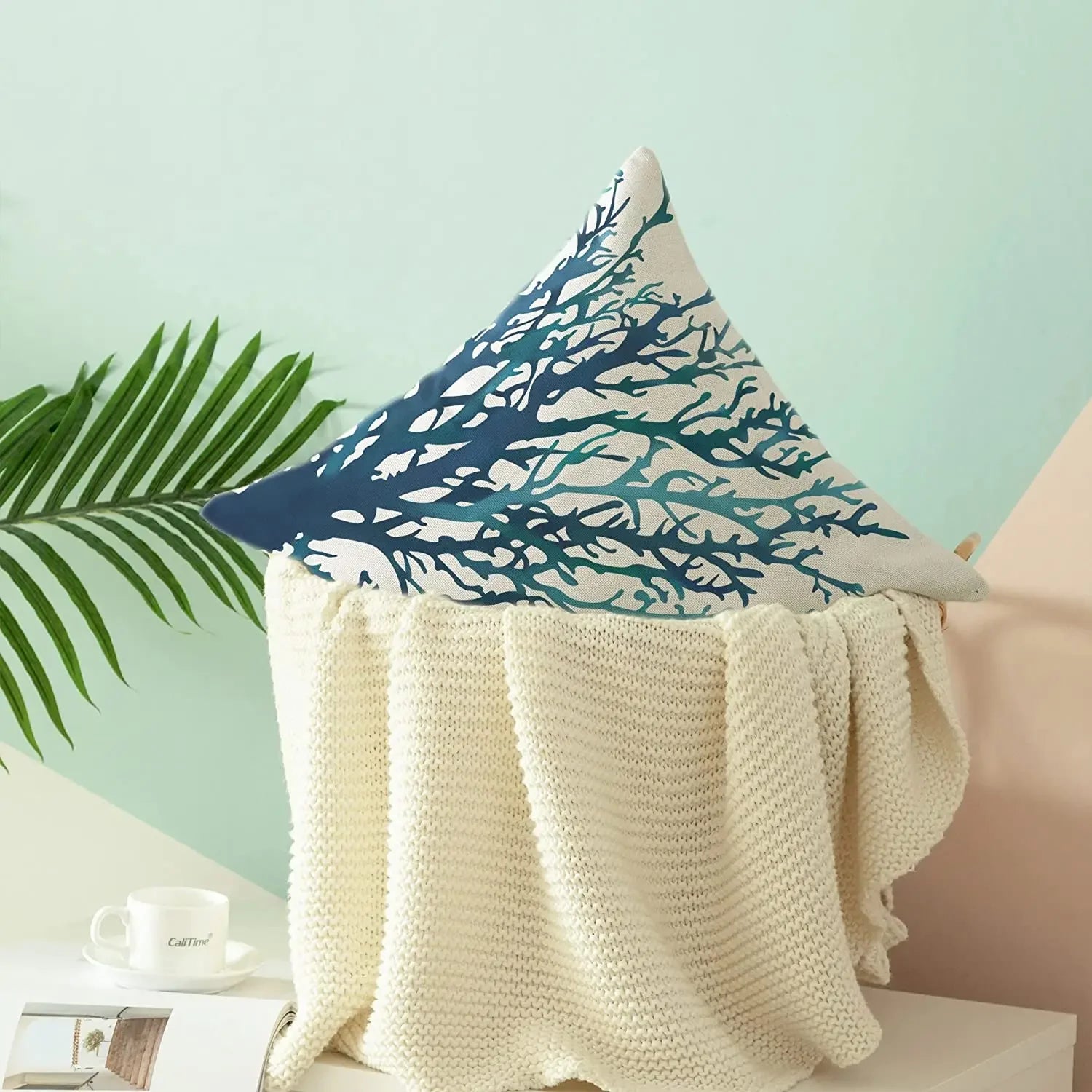 Decorative pillow with blue and white design on a light green background