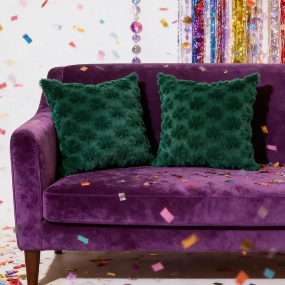 Purple couch with green textured pillows against a colorful confetti background