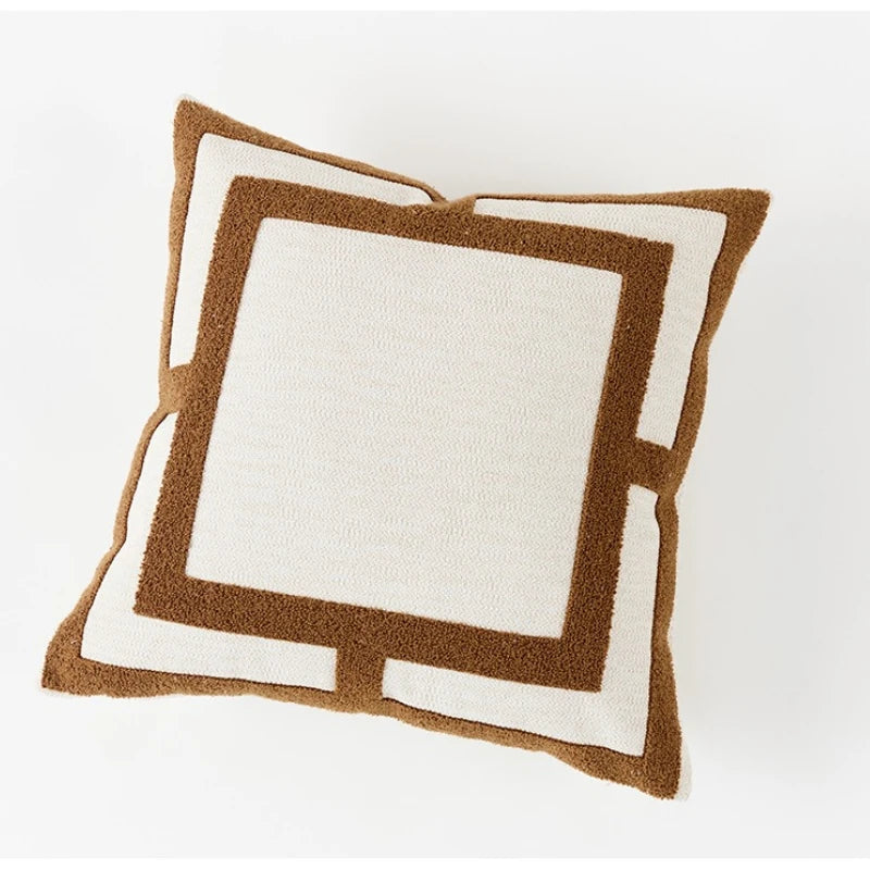 Decorative pillow with brown border on a white background