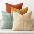 Colorful corduroy pillow covers in green, orange, and beige tones on sofa