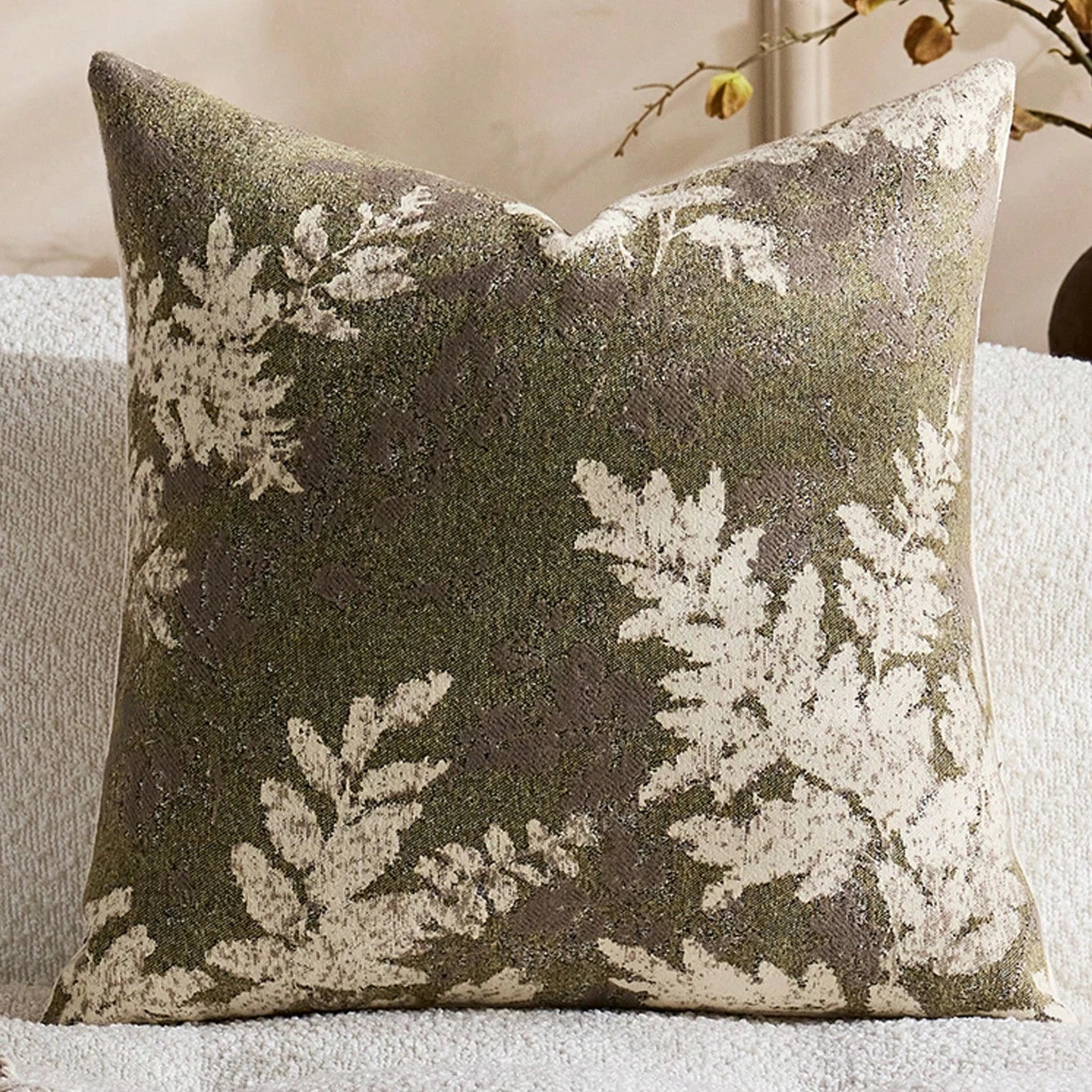 Decorative pillow with leaf pattern on a neutral background