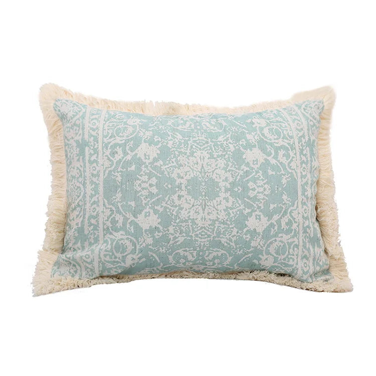 Decorative pillow with teal and beige pattern on a white background