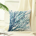 Decorative pillow with blue coral design on a neutral background