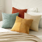 Green and yellow corduroy pillow covers on bed with soft texture