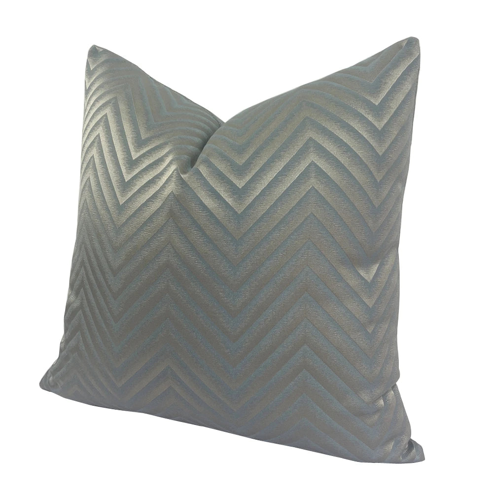 Gray pillow with chevron pattern on a white background