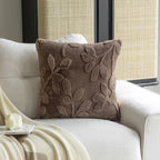 Brown textured pillow on a white sofa with a neutral background