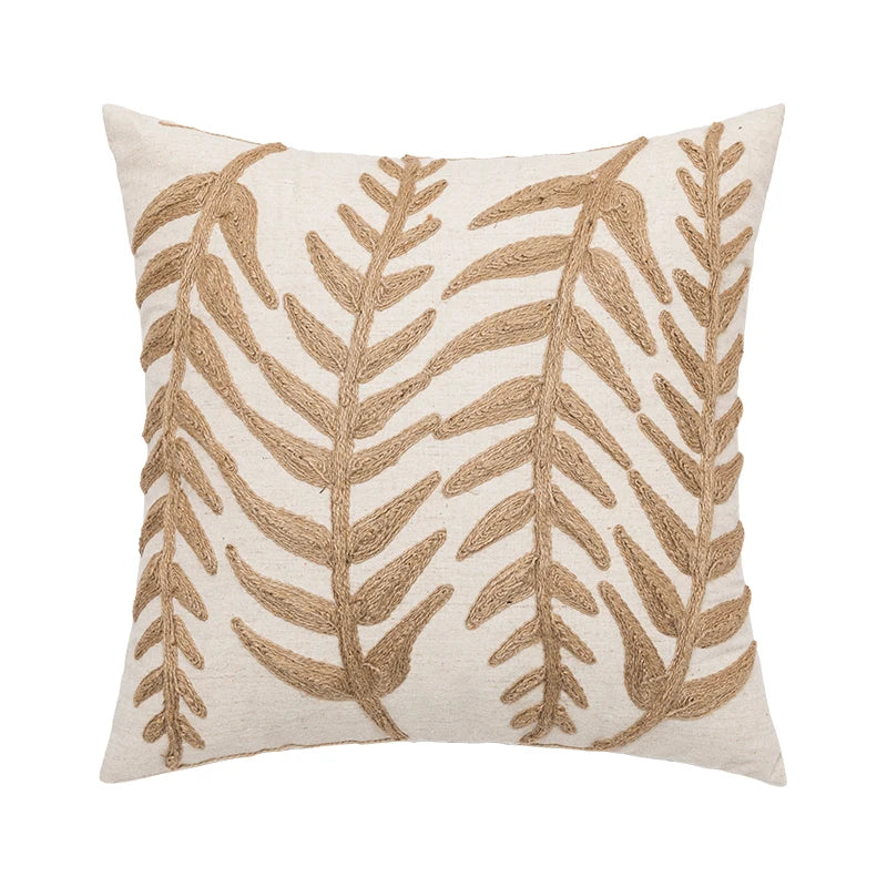 Linen cushion cover with embroidered leaf pattern in natural tones