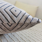 Textured pillow with geometric pattern on a neutral background