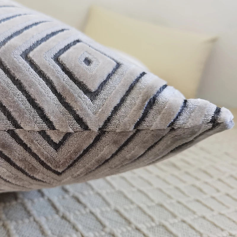 Textured pillow with geometric pattern on a neutral background