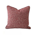 Red and brown patterned pillow on a white background