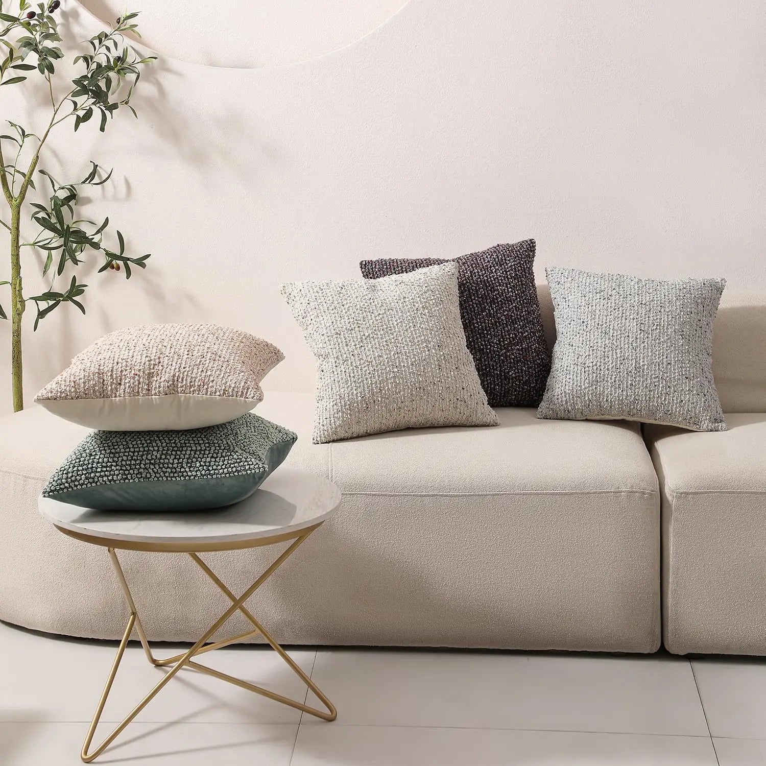 Minimalist living room with boucle textured pillows on modern sofa