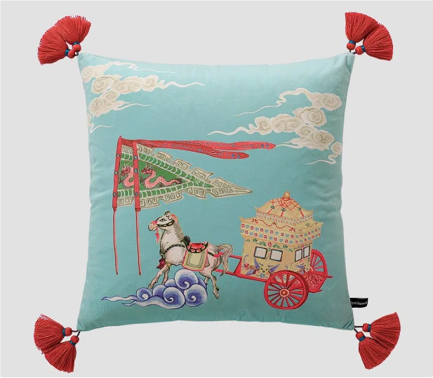 Decorative pillow with horse and carriage design on a light blue background