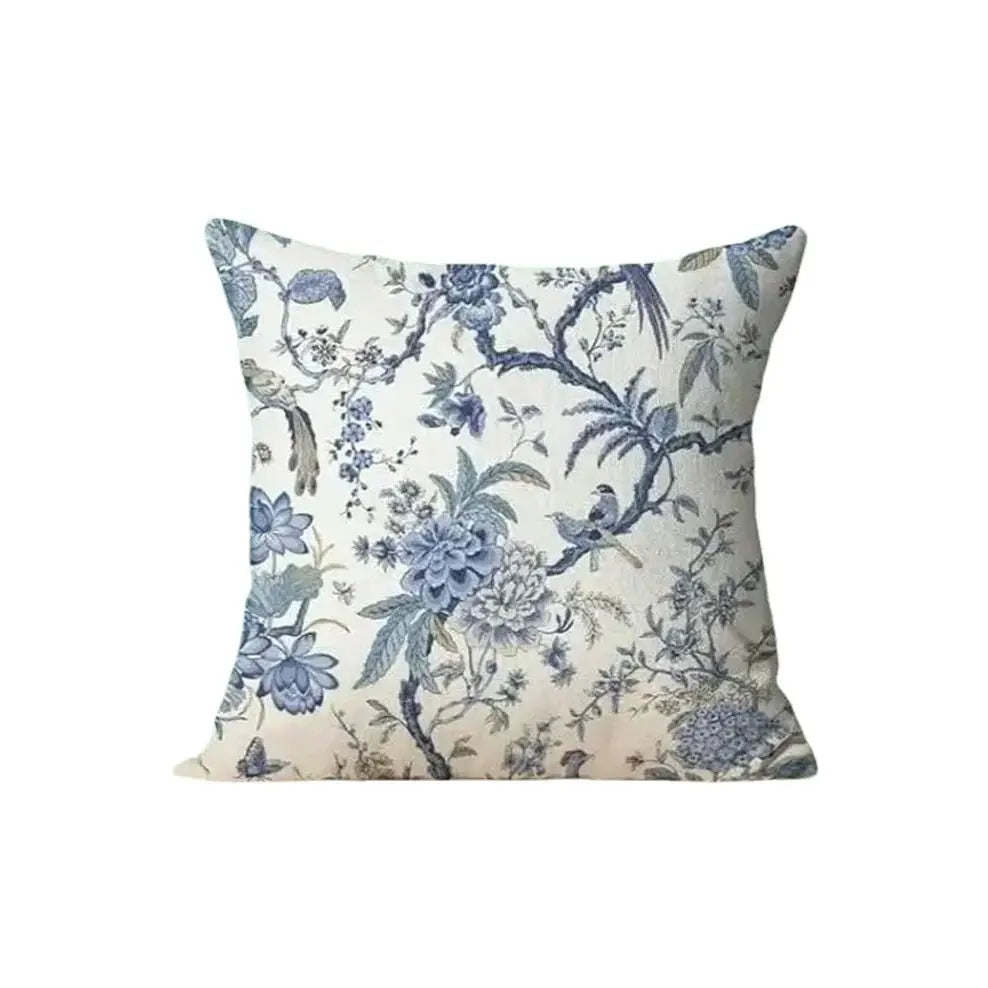 Decorative pillow with floral and bird pattern on a white background